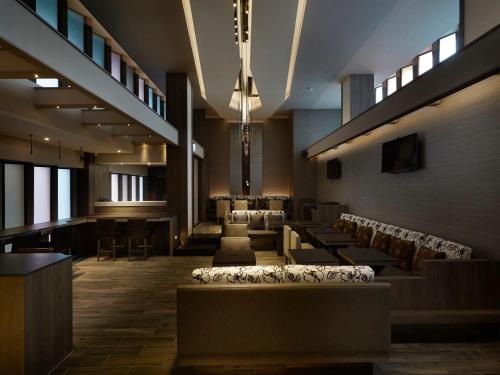 a lobby with chairs and tables in a building at At Home Hotel Ximen in Taipei