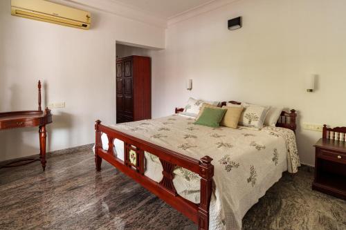 a bedroom with a bed and a piano at Orma in Cochin