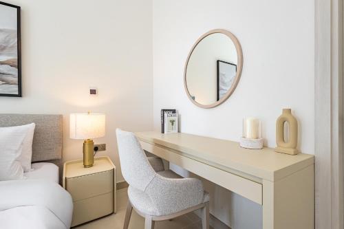 a bedroom with a desk and a mirror and a bed at Charming Studio next 5 min walk to Formula 1, Golf Course, and Yas Water World in Abu Dhabi