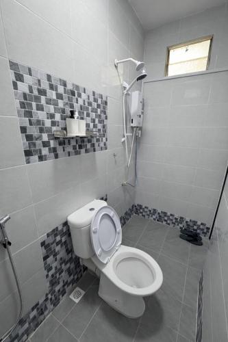 a bathroom with a toilet and a shower at DNH Nilam Puri Homestay Unit B in Kota Bharu