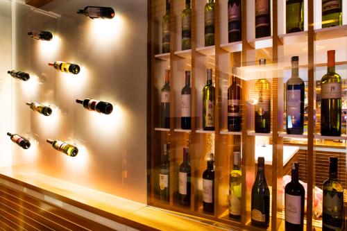 a display case filled with lots of bottles of wine at Hotel Navis in Orašje