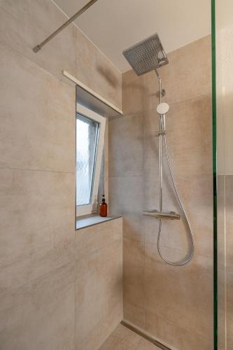 a bathroom with a shower with a glass door at Cocoa Suite · Kilchberg in Kilchberg