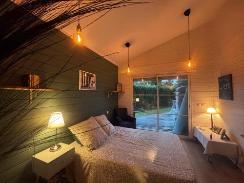 a bedroom with a large bed in a room at Entre bassin & océan in Lège-Cap-Ferret