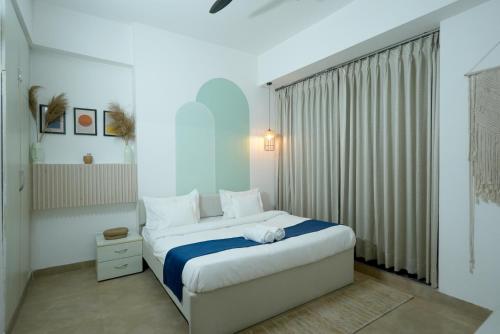 a bedroom with a large bed and a window at Hotel Nimantrana in Noida