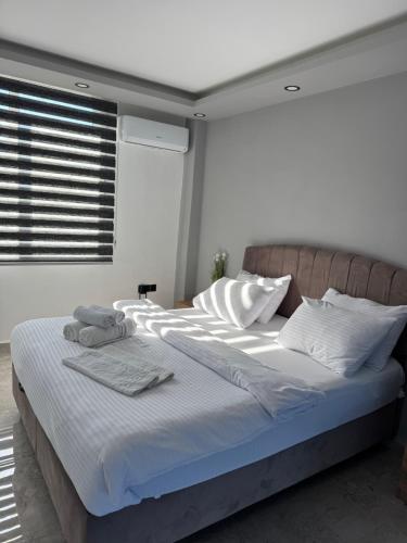 a bedroom with a large bed with white sheets and pillows at Veray Homes Villa in Ayios Dhometios