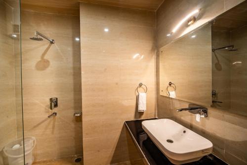 a bathroom with a sink and a shower at Vedikant Pine Tree Resort in Chail