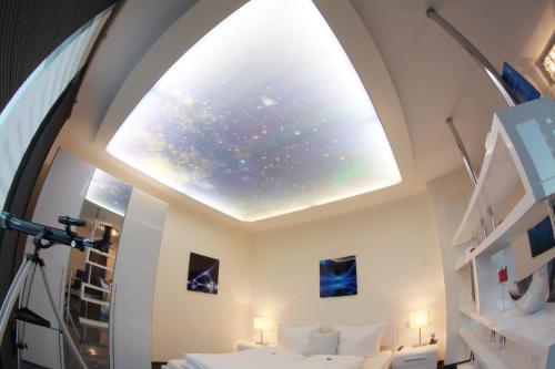 a room with a large window with a star ceiling at Hotel Jungstil in Darmstadt