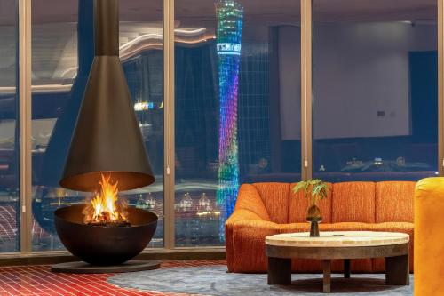 a living room with a couch and a fire pit at The Protons Guangzhou in Guangzhou