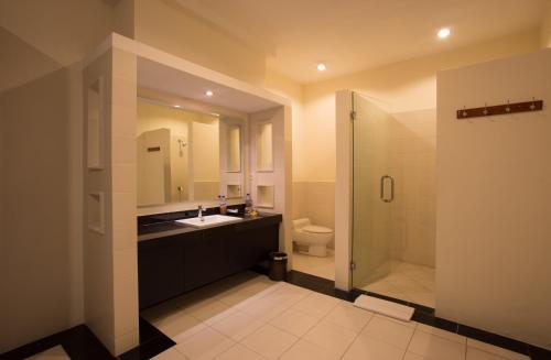 a bathroom with a toilet and a sink and a shower at The Yubi Boutique Villas Seminyak - CHSE Certified in Seminyak