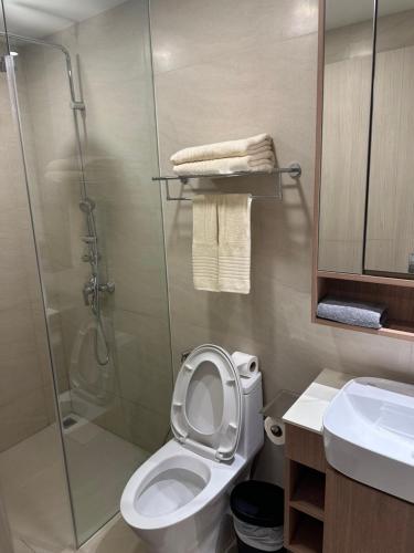 a bathroom with a shower and a toilet and a sink at Laguna SkyPark in Laguna Phuket