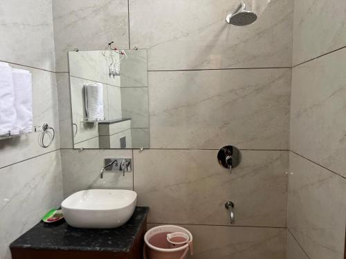 a bathroom with a sink and a mirror at Hotel Highway Retreat in Gajraula