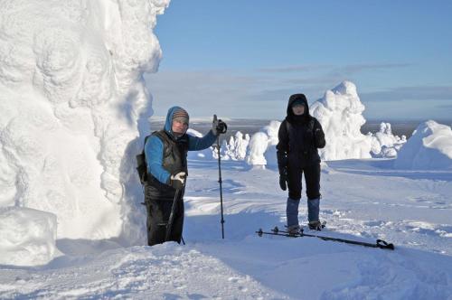 two people on skis standing in the snow at Lucky Ranch cabin 4 in Pyhätunturi