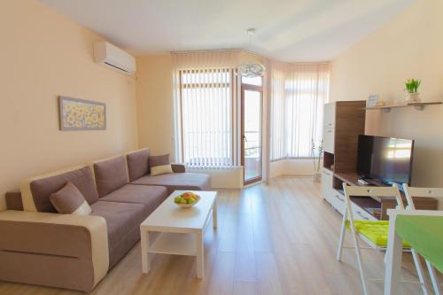 a living room with a couch and a table at Domus Apartments Old Town in Plovdiv