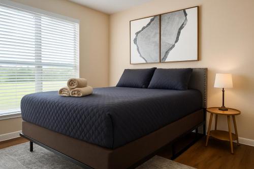 a bedroom with a bed with a teddy bear on it at Stunning 1BR near The Heights with BBQ, Gym & Pool in Houston