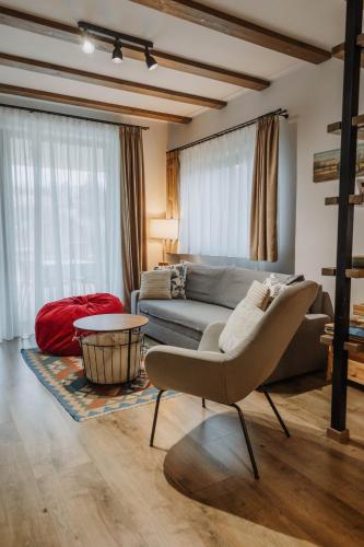 a living room with a couch and a table at Relax Balaton Apartmanok in Balatonfüred