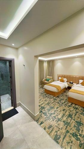 a hotel room with two beds in a room at نوف بلازا nouf plaza for serviced apartments in Ad Dawādimī