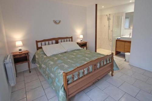 a bedroom with a large bed and a bathroom at Le monteil in Saint-Sornin-Leulac