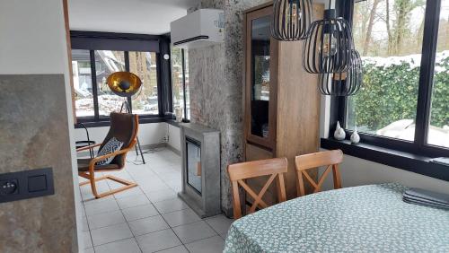 a room with a table and chairs and a fireplace at Opeteukske in Lanaken