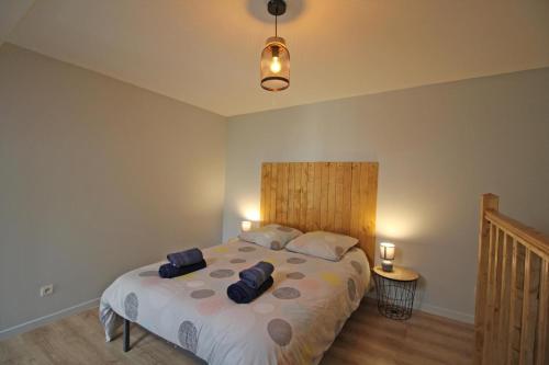 a bedroom with a large bed with two pillows at Familial 'le chiron' in Thiat