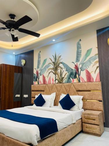 a bedroom with a large bed with blue pillows at MK House in Greater Noida