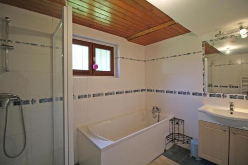 a bathroom with a tub and a sink and a shower at Beaufort in Blond