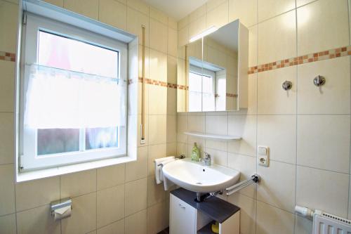 a bathroom with a sink and a mirror at Störtebeker in Norddeich