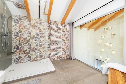 a bathroom with a shower and a bath tub at MyWinkl Design-Ferienwohnungen in Reit im Winkl