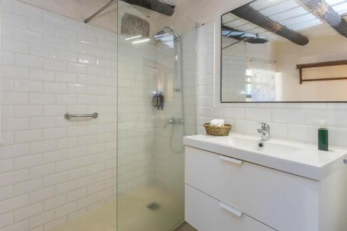 a bathroom with a sink and a glass shower at GuestReady - Hotel Rural Las Calas in Vega de San Mateo
