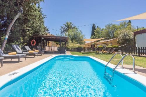 a swimming pool in the backyard of a house at GuestReady - Hotel Rural Las Calas in Vega de San Mateo