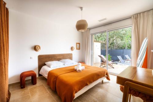 a bedroom with a bed with a teddy bear on it at Maison Jeannot - Climatisée avec piscine in Vers Pont du Gard