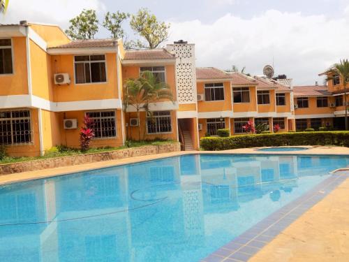 a large swimming pool in front of a building at Hotel Oasis in Morogoro