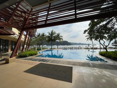 a sign that reads age top vacation club next to a swimming pool at Beach condos at Pico de Loro Cove & possible Beach Club Access & Wi-Fi & Netflix, 42-50''TVs with Uratex beds & pillows, equipped kitchen, balcony, parking, guest registration fee is not included in Nasugbu