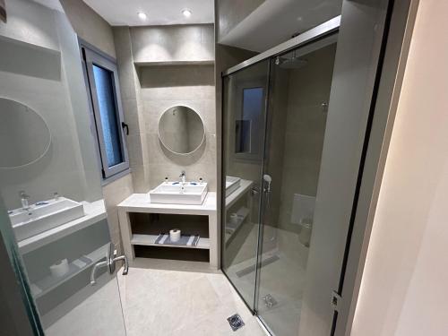 a bathroom with a sink and a shower at Amalia Sea Hotel in Rhodes Town