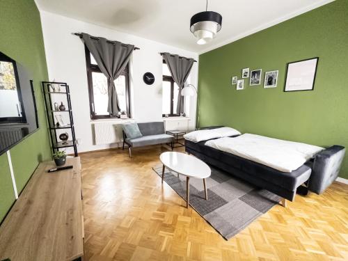 a bedroom with a bed and a table and a chair at Erstklassige 3-Zimmer Wohnung in Leipzig