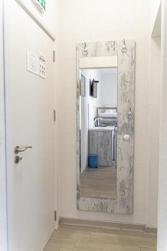 a hallway with a mirror and a room at ELPIDA Suites - Mandra, Greece in Mándra