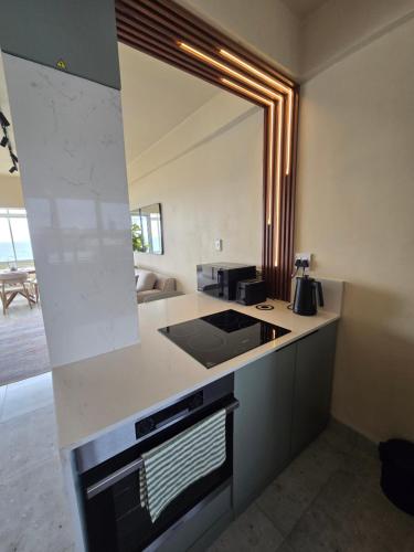 a kitchen with a sink and a mirror at 407 Afsaal in Amanzimtoti