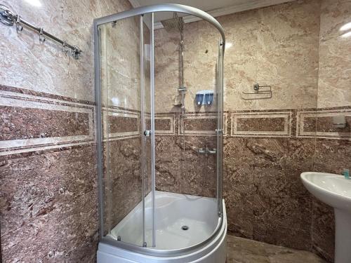 a shower with a glass door in a bathroom at GuestHouse Old Avlabari in Tbilisi City
