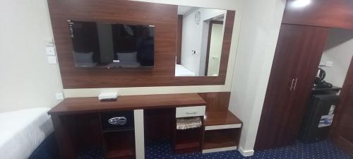 a bathroom with a wooden vanity with a mirror at Maysan Al Mahbas Hotel in Al Khansāk