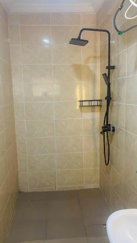 a bathroom with a shower and a sink at Perfect Home in Lagos