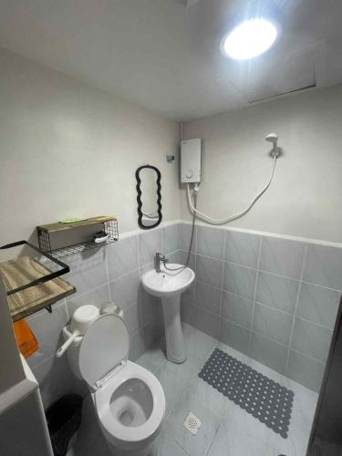 a bathroom with a toilet and a sink at Affordable Condo Unit in Saekyung Phase 3 in Suba