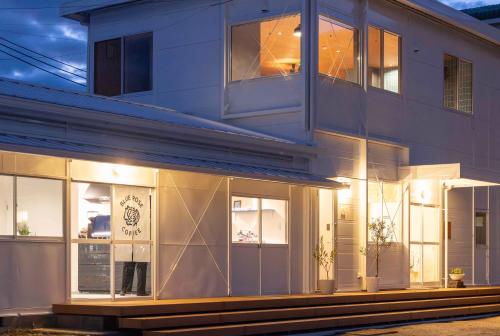 a building with large windows on the side of it at TATARA FACTORY stay in Imabari