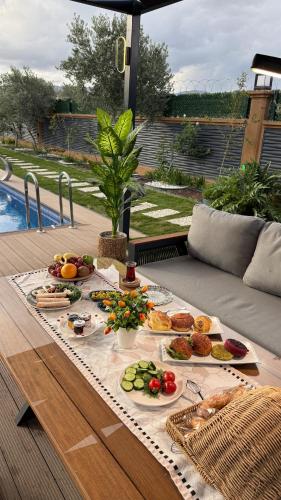 a table with many plates of food on it at Akcavillagarden in İzmir