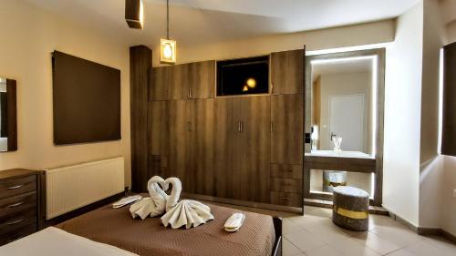 a bedroom with a bed with two swans on it at The Bazaar Refuge in historical centre in Preveza