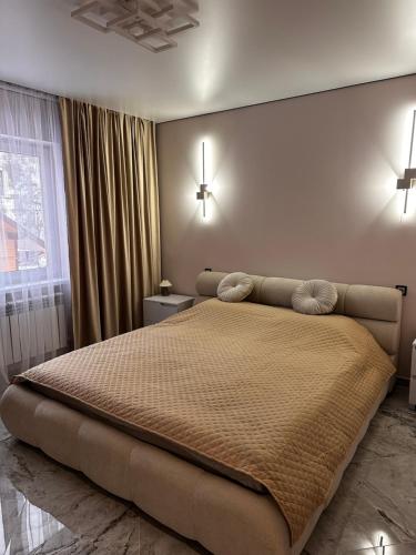 a bedroom with a bed with two pillows on it at Grey House in Slavske