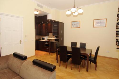 a kitchen and dining room with a table and chairs at Gozsdu Court Budapest in Budapest