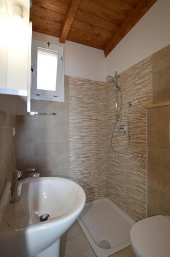 a bathroom with a sink and a shower at Settebello Village in Lido Di Fondi