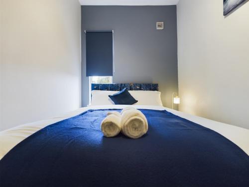 a bedroom with a bed with two hats on it at Pottery House - Stoke on Trent -Free parking- Central Location - Sleep 8 in Stoke on Trent