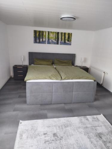 a bedroom with a large bed in a room at FeWo Waldblick in Goslar