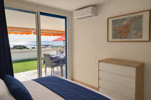 a bedroom with a bed and a view of a patio at Azahara Beach in Arona