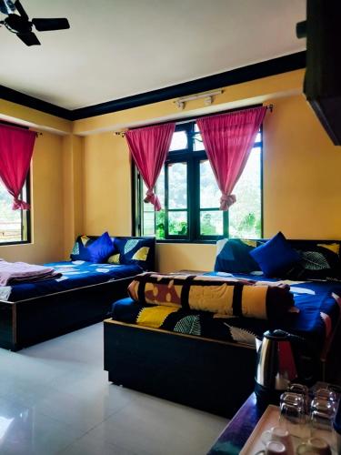 two beds in a room with windows and pink curtains at Aurora Farmstay in Rongli